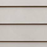 External Cladding - Upgrade Weathertex Classic Smooth Close-up view of beige horizontal siding panels, commonly used as exterior cladding on buildings. The panels are smooth, evenly spaced, and create a simple, uniform pattern.